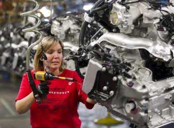 Engine Specialist Jennifer Souch assembles a Camaro engine in the GM factory in Oshawa, Ontario on Friday, Summer 10, 2011.