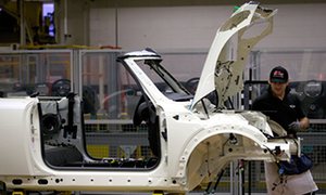 Factory workers create Mini automobiles