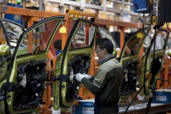 Susana Gonzalez/Bloomberg Information - a worker works on the assembly-line making the Ford Fiesta at a plant in Cuautitlan Izcalli, Mexico, this season.