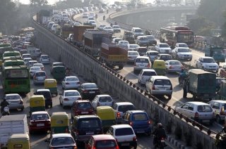 Traffic moves along a busy road in New Delhi January 11, 2011. REUTERS/B Mathur