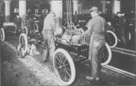 Workers install engines on Model Ts at a Ford engine business plant. The photo is from about 1917.